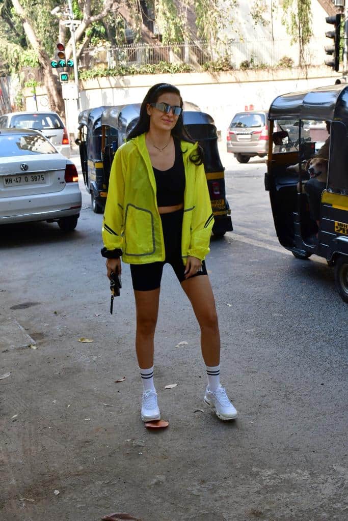 Stunned in black shorts with neon jacket