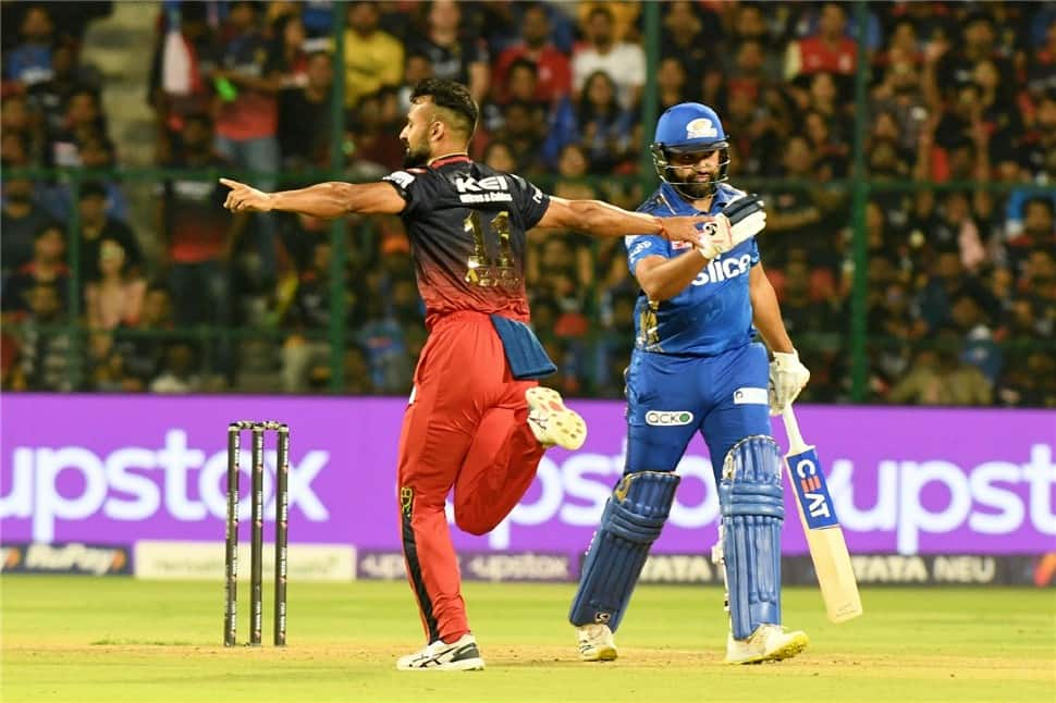 MI skipper Rohit Sharma (right) walks off the field after being dismissed for 1 by RCB all-rounder Akash Deep. (Photo: ANI)