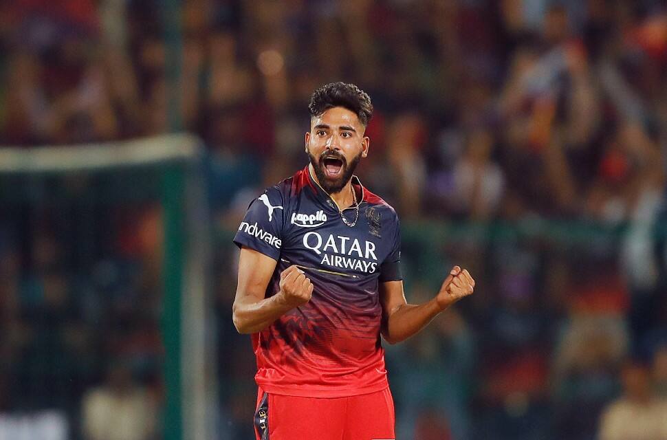 RCB pacer Mohammed Siraj celebrates after picking up the wicket of MI opener Ishan Kishan for 10. Siraj was pick of the RCB bowlers, claiming 1/21 in 4 overs. (Photo: ANI)