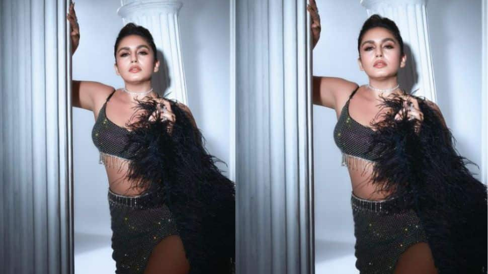 Huma Qureshi in shimmery black thigh high slit dress