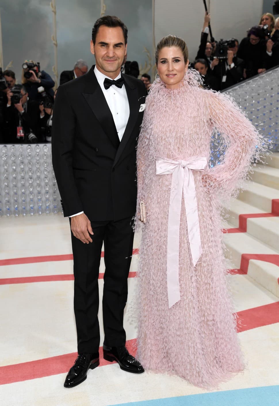 Tennis legend Roger Federer was seen in a sharp black Dior tuxedo at the Met Gala 2023. His wife, Mirka, balanced him out in a feathery long-sleeve gown with a bow accent, one of Lagerfeld's signature accessories. (Photo: AP)