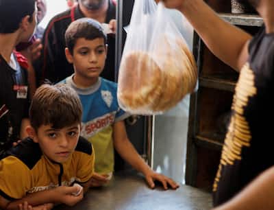 People Wait To Buy Food In Gaza Strip