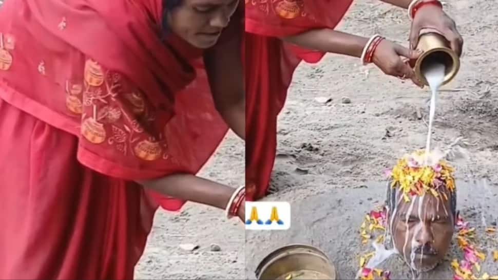 Pati Parmeshwar? Woman buries husband to the neck, performs `pooja` on his head | VIRAL VIDEO