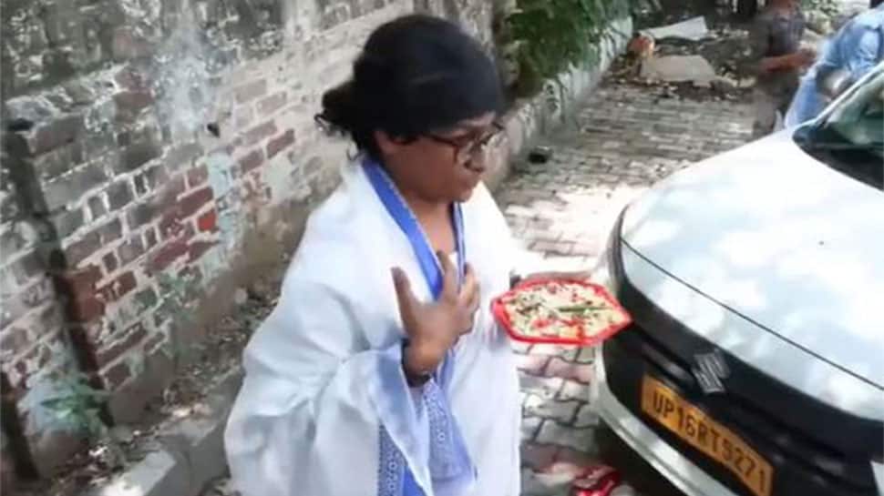 Mimicry artist Ratan Ranjan performs a satirical skit dressed as CM Mamata Banerjee