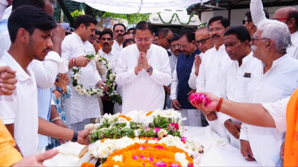 Uttarakhand CM Pushkar Dhami pays final respects to BC Khanduri in Dehradun