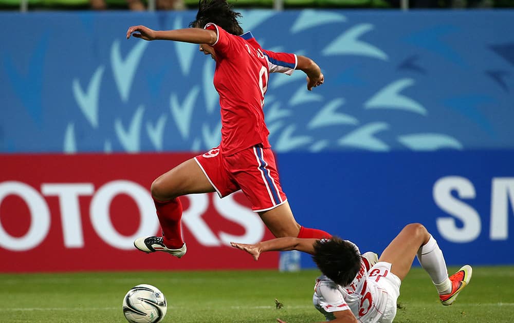 North Korea's Yuri Jong leaps over Vietnam's Hoang Quynh Pham during their women's first round group C soccer match at the 17th Asian Games in Incheon, South Korea.