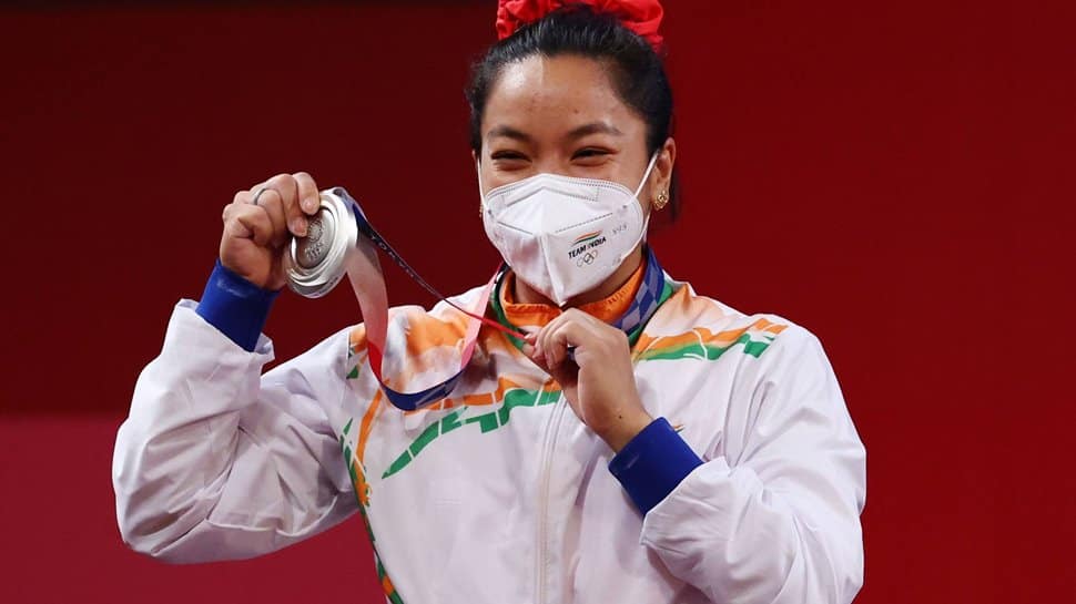 Mirabai Chanu poses with her silver medal at Tokyo Olympics