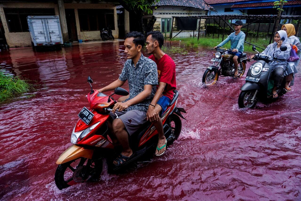 Flood water turns red after hitting dye factory