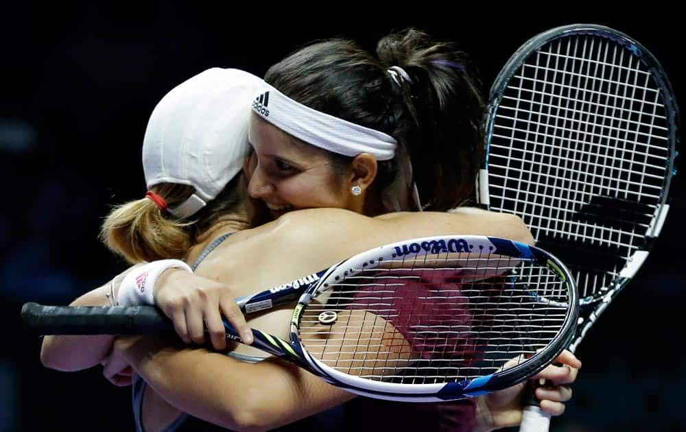 Zimbabwe's Cara Black, left, and India's Sania Mirza embrace as they celebrate after defeating Taiwain's Hsieh Su-Wei and China's Peng Shuai in the doubles final at the WTA tennis finals in Singapore.