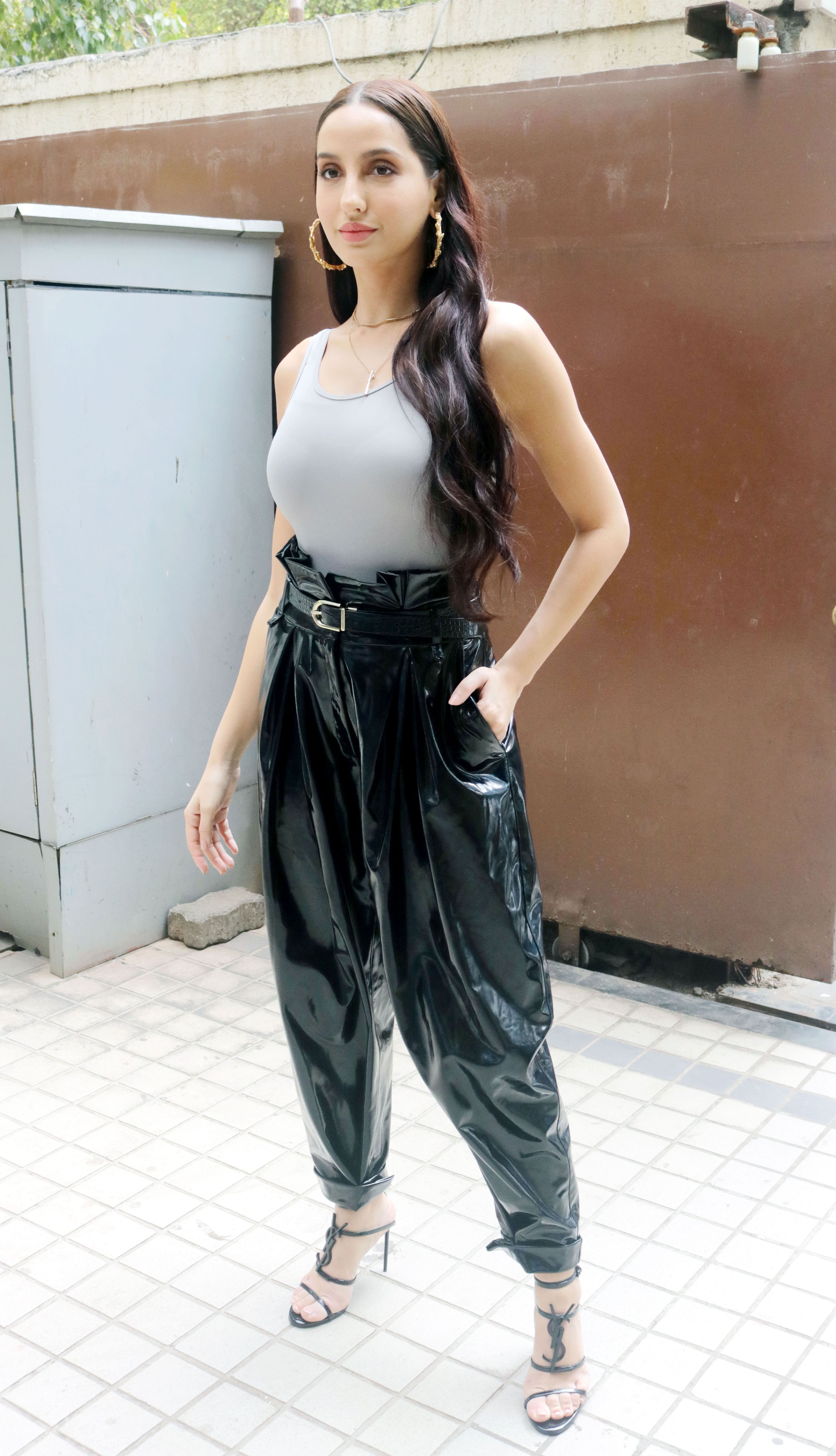 Nora Fatehi teams all-black top and leather pants with boots and