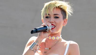 Miley Cyrus goes topless yet again