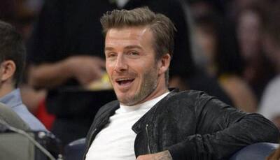 Soccer star David Beckham and son unhurt in UK car crash
