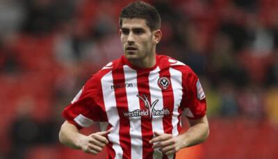 Oldham manager says board mulling Ched Evans move