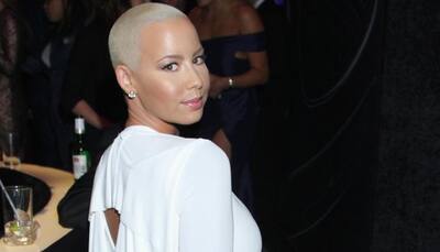 Amber Rose poses almost nude while sun-tanning