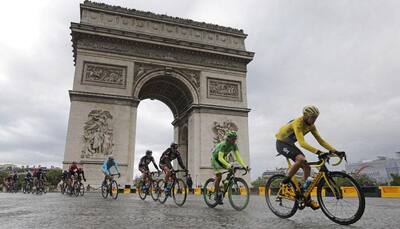 Manhunt in Paris after car smashes Tour de France barrier