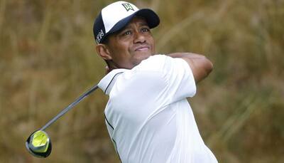 Tiger Woods grabs share of lead at Wyndham
