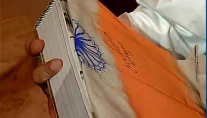 PM Narendra Modi signs &#039;flag&#039;, sparks controversy; govt says it was not tricolour