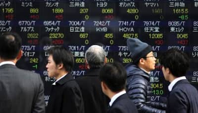 Asian shares slide halts but weak commodity outlook weighs