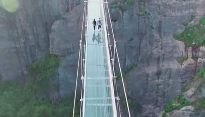 Watch Video - World's highest glass-bottom bridge opens in China 600 feet above a canyon!