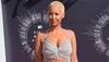 Amber slams magazine for calling her Kanye's 'infamous ex'