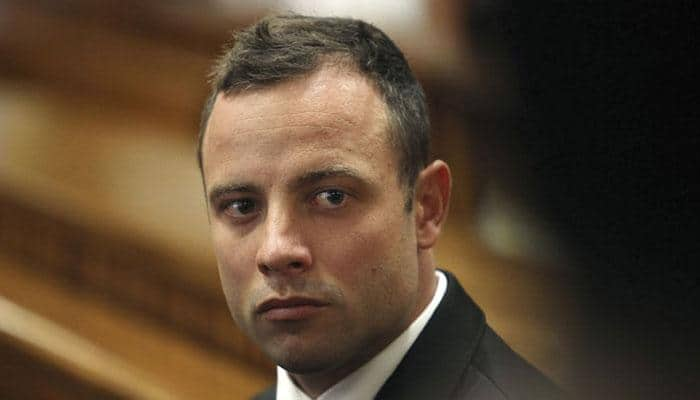 Oscar Pistorius walks into police station for community service