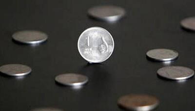 Rupee down 10 paise to 66.92 against dollar in early trade