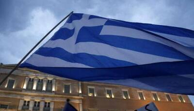 Greece backs down on IMF role in bailout