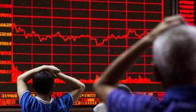 China shares end at 14-month lows after late selling frenzy