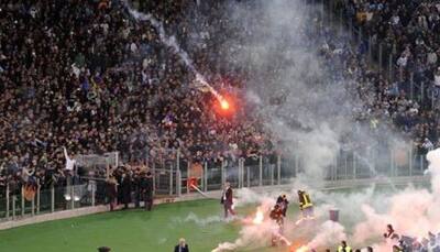 VIDEO: Fire in dug-out – Watch football fans firing flares at rival camp
