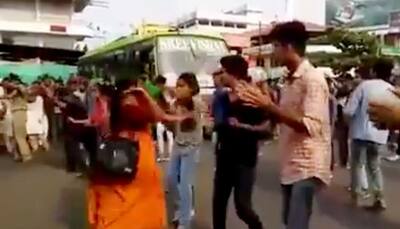 Angry woman slaps girl during flash mob for interrupting traffic in Kerala - Watch