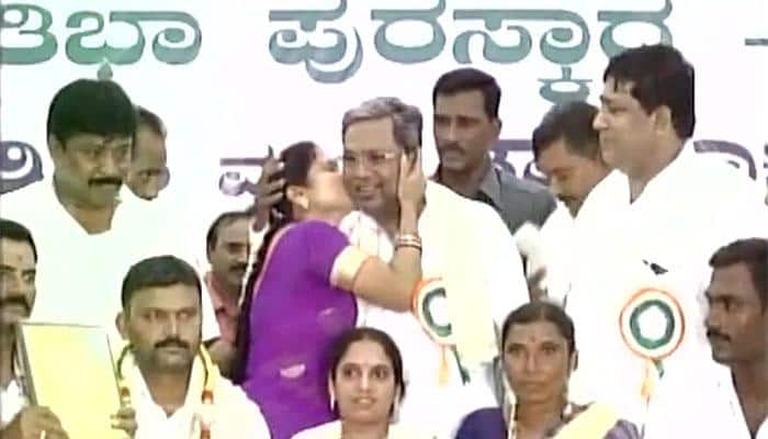 Oops! Karnataka CM Siddaramaiah gets kissed by woman in public — Watch video