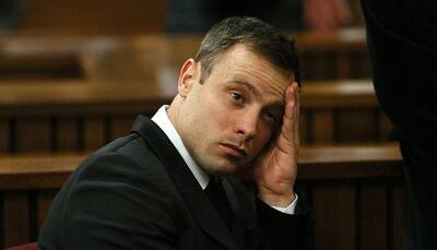 Paralympian Oscar Pistorius arrives in court for sentencing on murder conviction