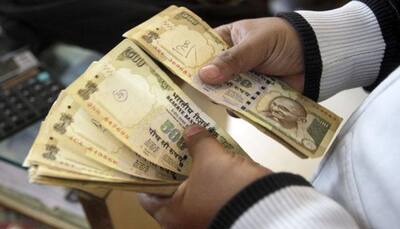 Rupee climbs 26 paise against dollar