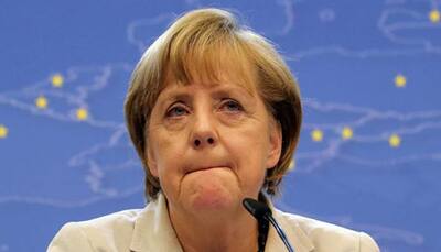Merkel 'firmly' rejects reversing refugee policy after attacks