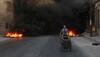 Syrian children burn tyres to obstruct warplanes bombarding besieged Aleppo