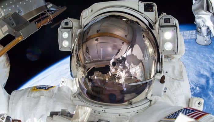 NASA astronauts conduct spacewalk to install docking adaptor
