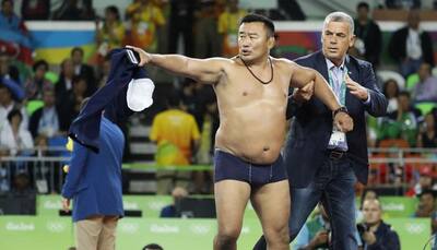 WATCH - BIZARRE! Mongolian wrestling coaches STRIP to bare minimum after unfavorable decision 