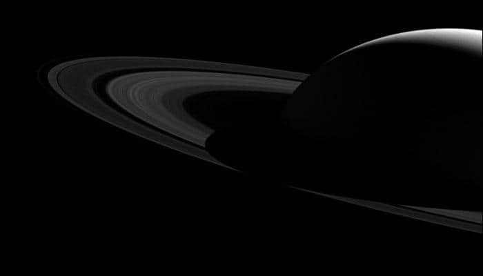 Behind the shadows: NASA&#039;s Cassini captures Saturn&#039;s silhouette over its rings in a stunning image!