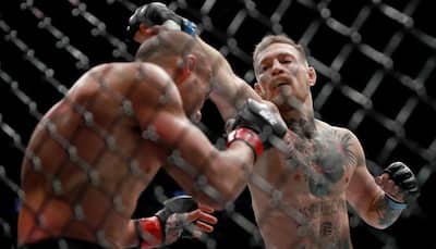 WATCH: Conor McGregor knocks out Eddie Alvarez to simultaneously hold two UFC belts