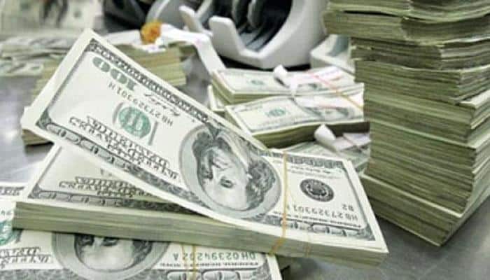 US Dollar hits 14-year high; oil dips in choppy trade