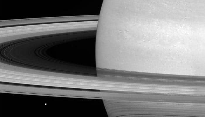 Saturn&#039;s icy moon &#039;Mimas&#039; dwarfed by huge rings