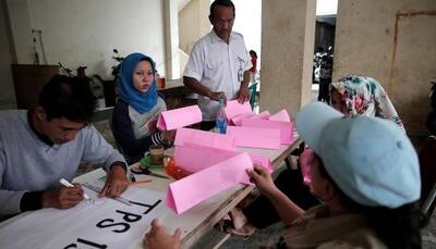 Jakarta election heads for second round as Christian governor holds narrow lead