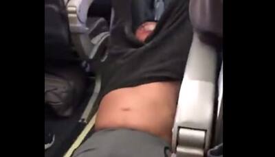Asian doctor dragged off United Airlines flight; videos spark uproar - Watch