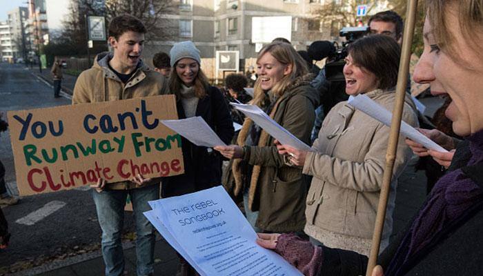 Environmental protesters return to Washington as Trump passes milestone