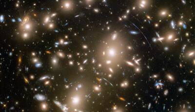 NASA's Hubble telescope captures massive galaxy cluster 6 billion light years away