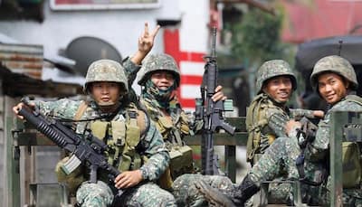 Philippines urges Islamist rebels to surrender as battle enters eighth day