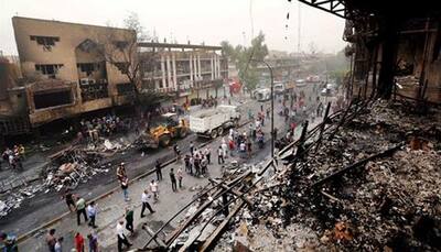 Woman detonates bomb in crowded market in Iraq, killing at least 30