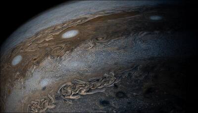 Jupiter gives a brilliant full view of its bands of clouds to Juno in enhanced colour! - See pic