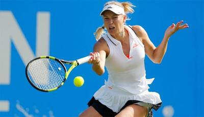 Wimbledon 2017: Caroline Wozniacki overcomes wobble at All England Club to book round-two spot