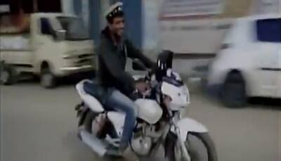 Drunk man in Karnataka steals police bike, cap, gives a tough chase - WATCH